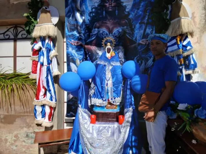 Peregrinos caminando bajo la lluvia durante la procesión de la Virgen de Regla en Cuba.